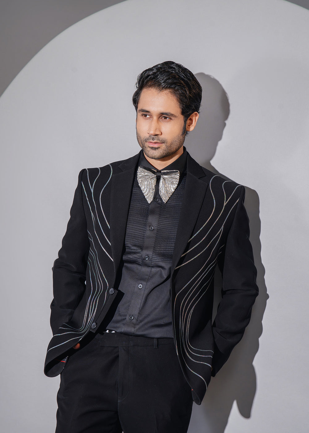 Black asymmetrical tuxedo set for men, featuring elegant Dana work for a stardust-inspired formal look.