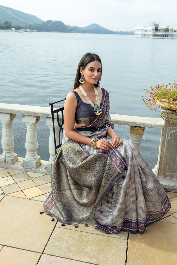 Elegant silk saree with all-over zari design and floral contrast border