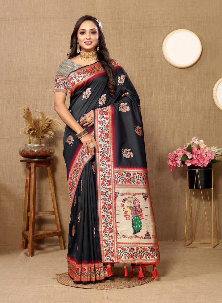 Sophisticated black silk saree with zari border and chic tassels, perfect for festive gatherings.