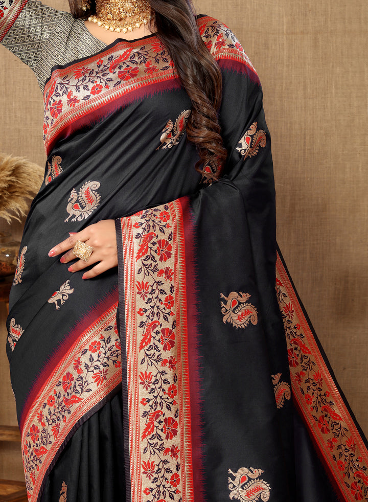 Timeless black silk saree with rich zari border and tassels, perfect for cultural celebrations.