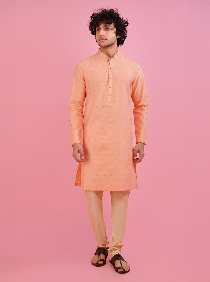 Elegant coral peach silk jacquard kurta pajama for men, featuring intricate embroidery.