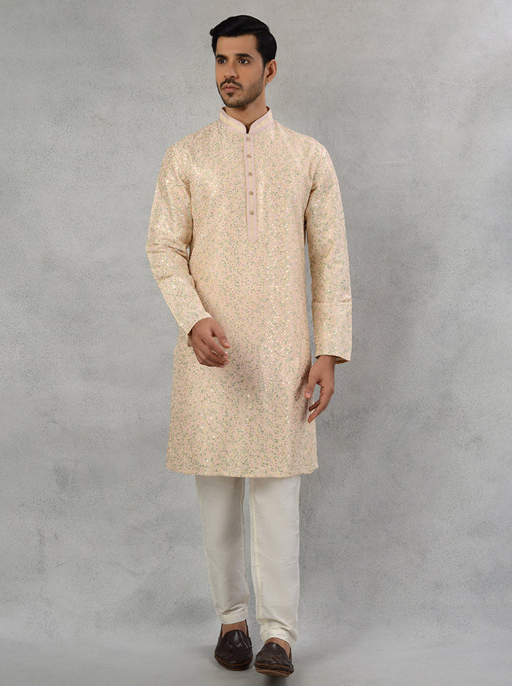 Traditional embroidered peach kurta pajama for men's festive occasions.