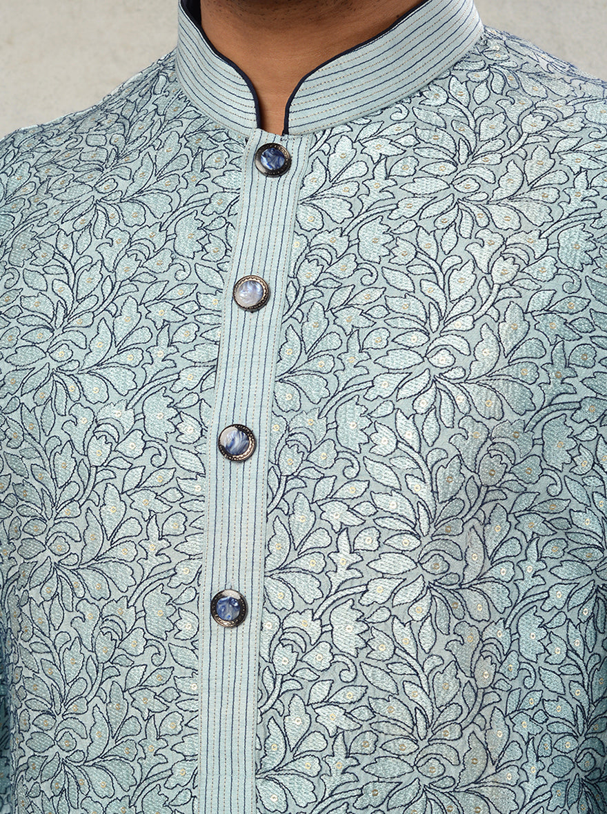 Men's dusty blue kurta pajama with classic straight cut and intricate embroidery.