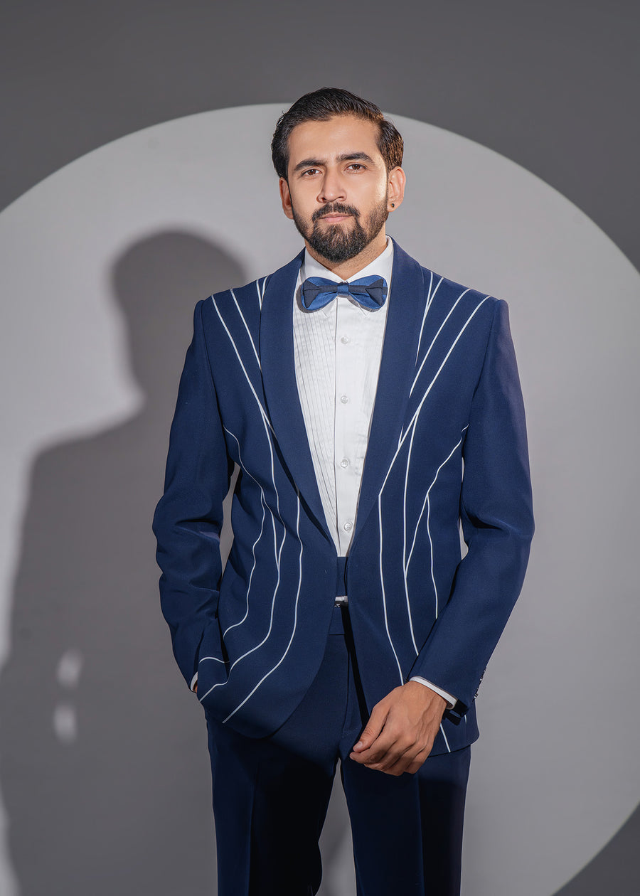 Blue wedding tuxedo for men with fluid radium lines, complemented by a white pleated shirt, designed for special days.