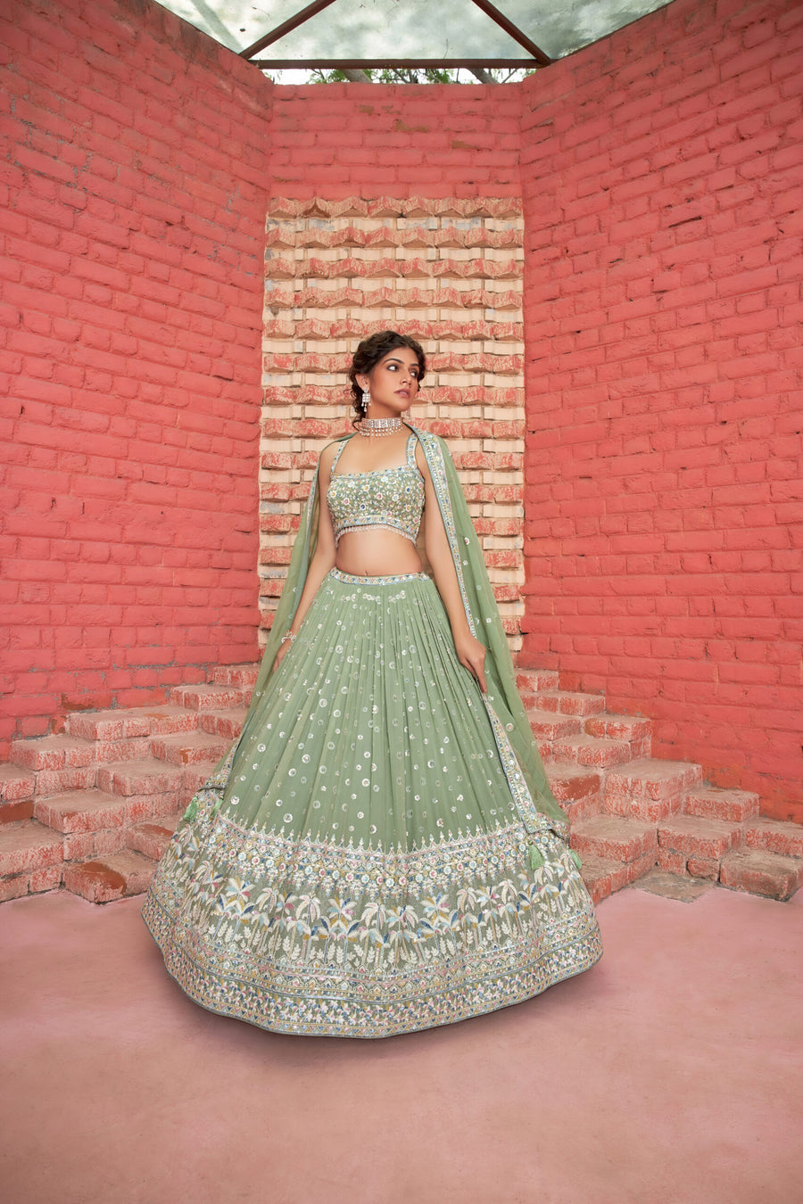 Elegant sage green georgette lehenga choli adorned with sequins, perfect for traditional celebrations and festive occasions.