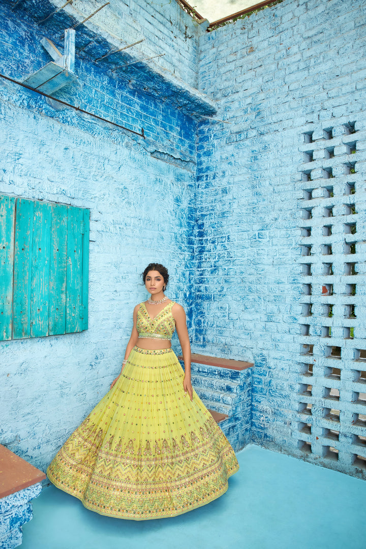 Stunning yellow lehenga set in georgette, adorned with sequins embroidery and a matching dupatta, perfect for celebrations.