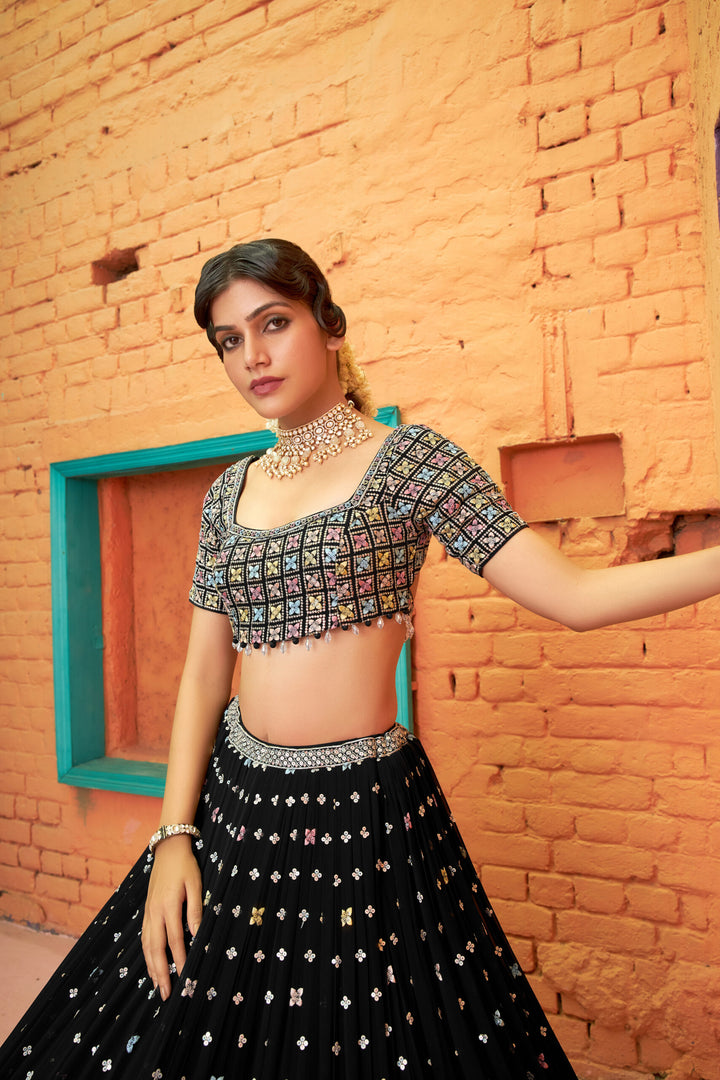 Chic black chiffon lehenga choli with a beautifully designed top and flowing dupatta, ideal for weddings and parties