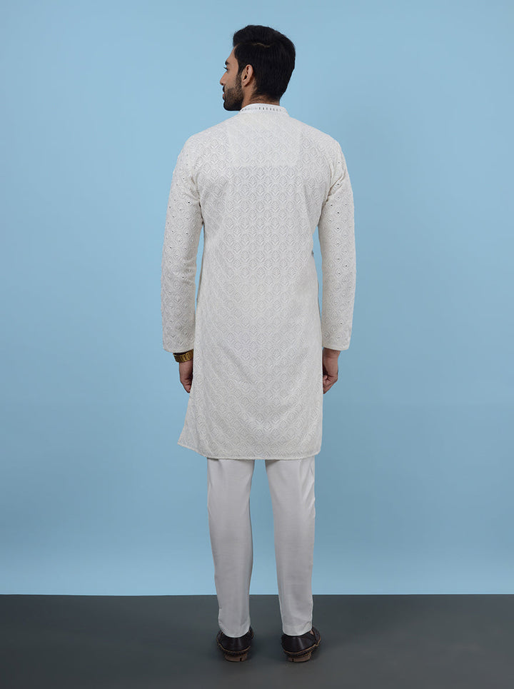 Unique embroidery adds charm to this cream kurta pajama for a fashionable look.