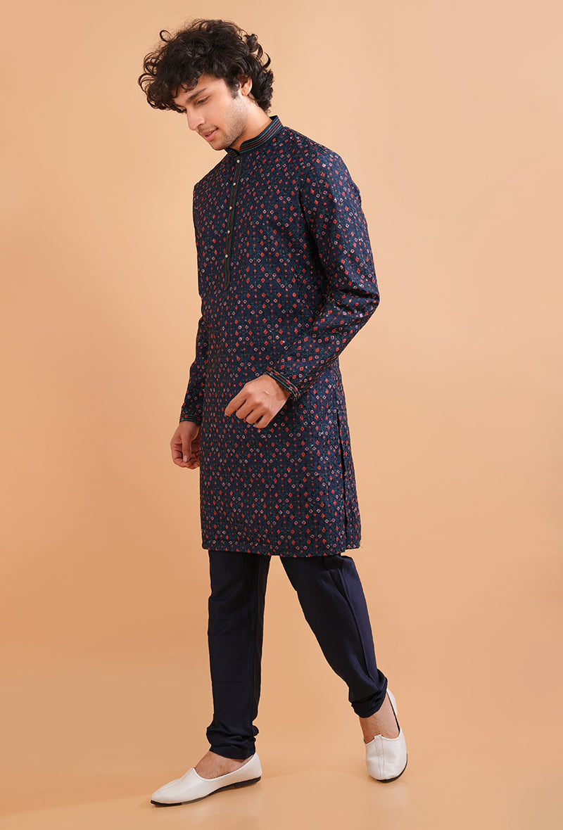 Navy blue silk kurta pajama set for men with intricate embroidery, perfect for formal occasions.