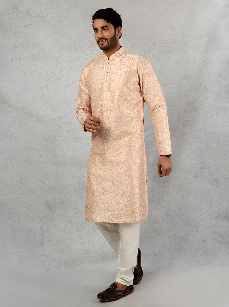 This beige embroidered kurta pajama enhances your festive wardrobe, making a statement.