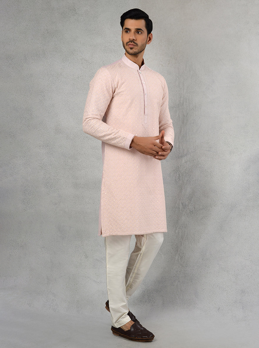 Celebrate in elegance with this blush pink kurta pajama crafted for special events.