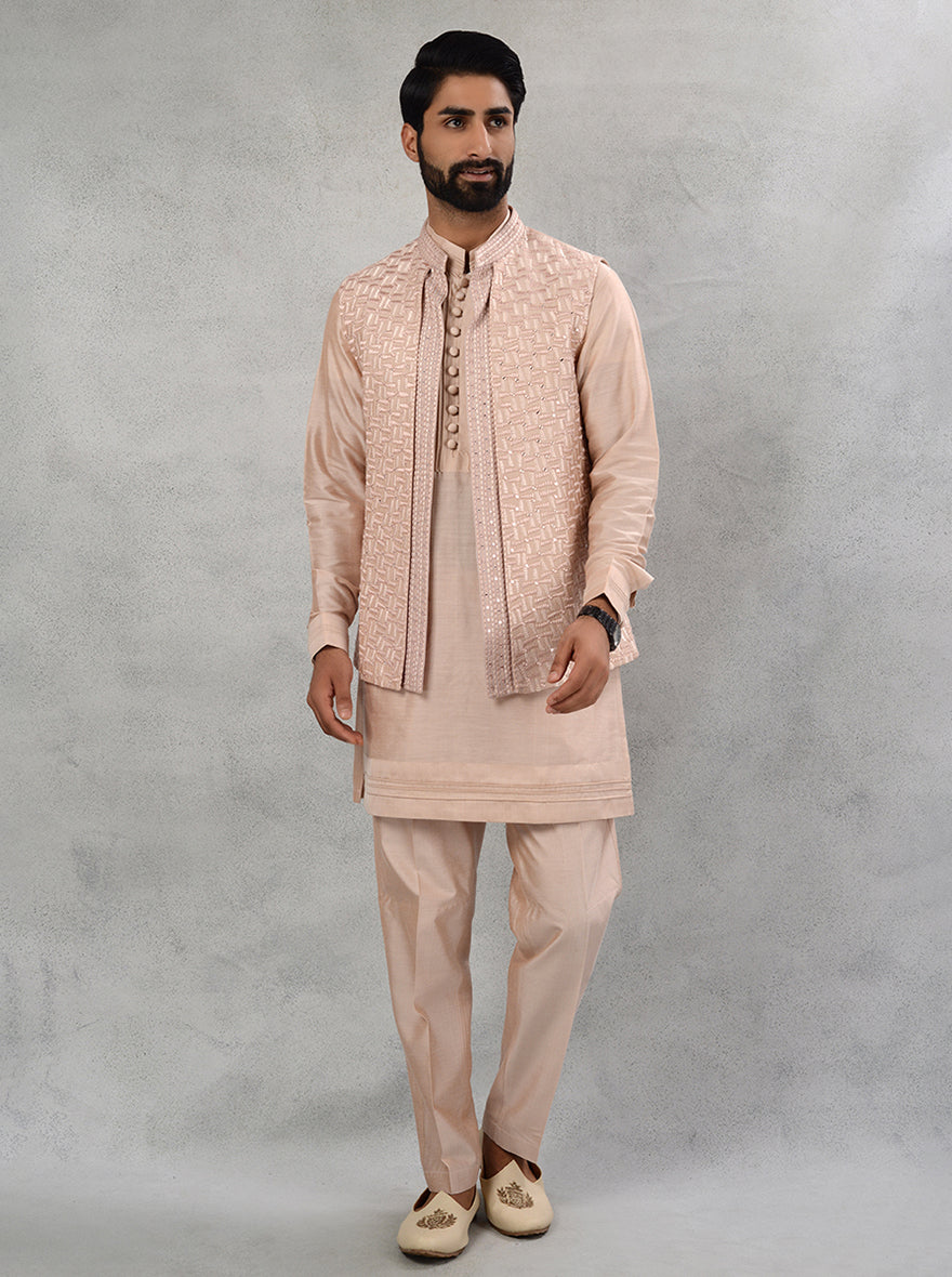 Celebrate in style with this embroidered peach kurta set designed for modern men in the USA.