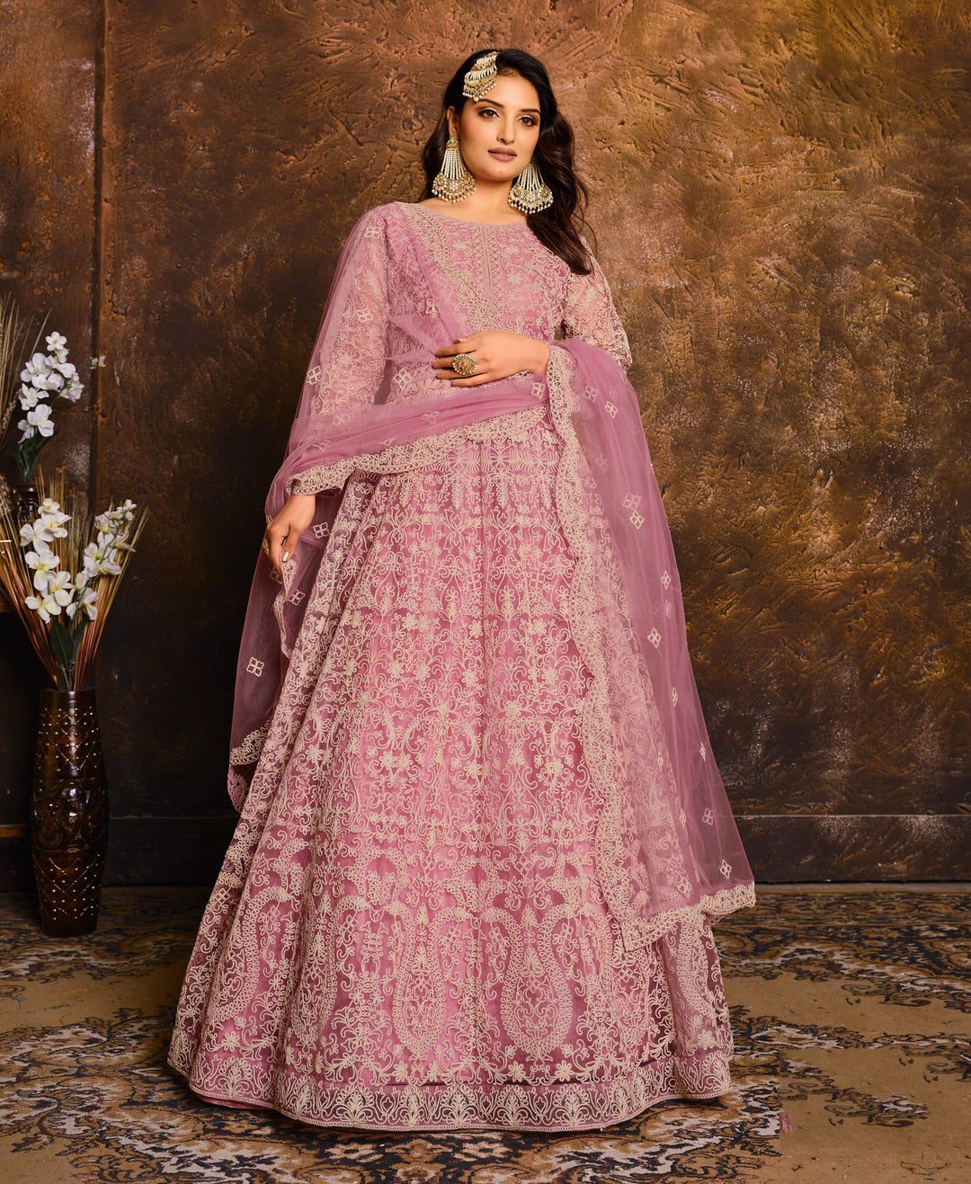 Beautiful pink women's salwar kameez, perfect for special occasions, featuring elegant embroidery and stylish design.