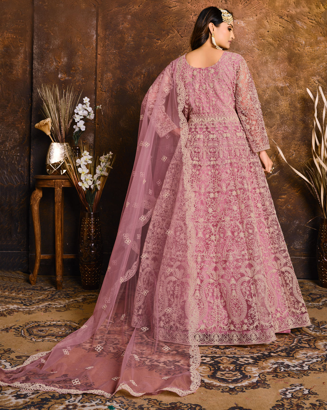 Stunning pink salwar kameez set, ideal for weddings and celebrations with luxurious fabric and intricate detailing.