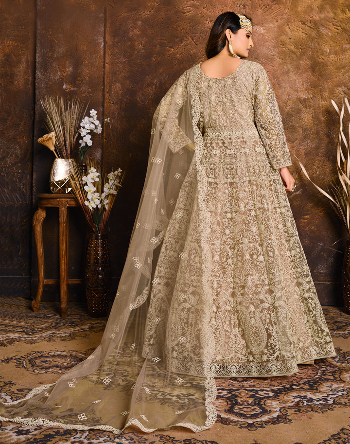 Beautifully crafted beige traditional salwar kameez set, ideal for weddings and gatherings with luxurious fabric.