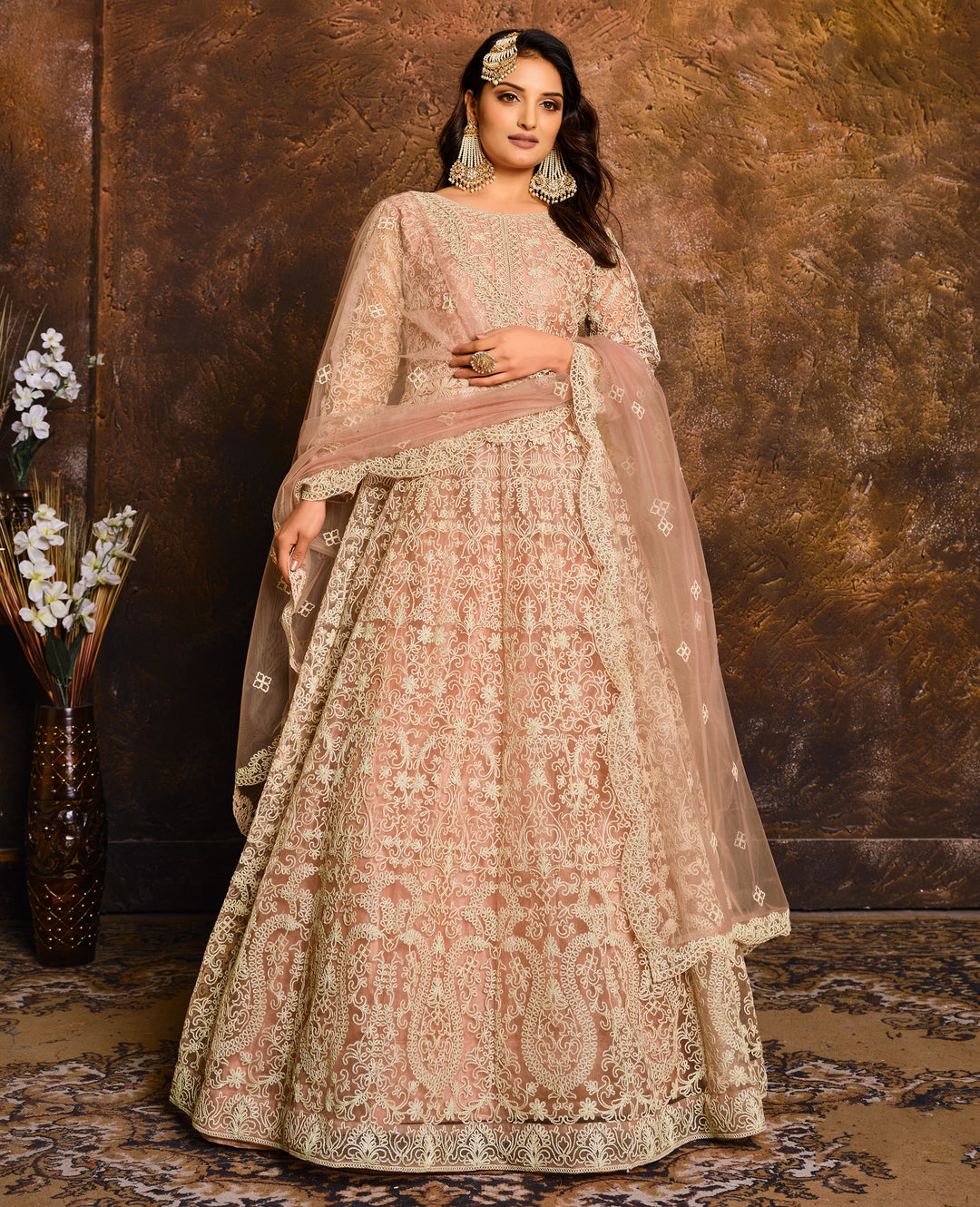 Enchanting peach salwar kameez set, perfect for celebrations, featuring exquisite detailing and elegant design.