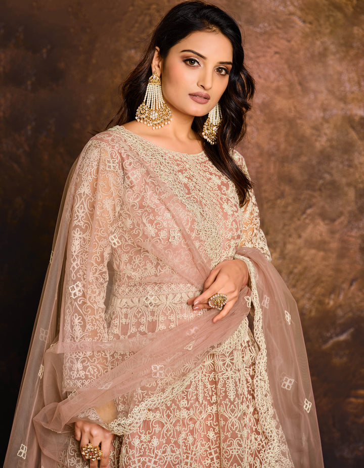 Chic peach salwar kameez showcasing intricate craftsmanship, designed for modern women celebrating special events in the USA.