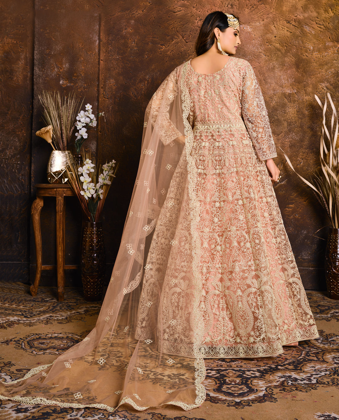 Beautifully crafted peach salwar kameez set, ideal for weddings and festive gatherings with luxurious fabric and embellishments.