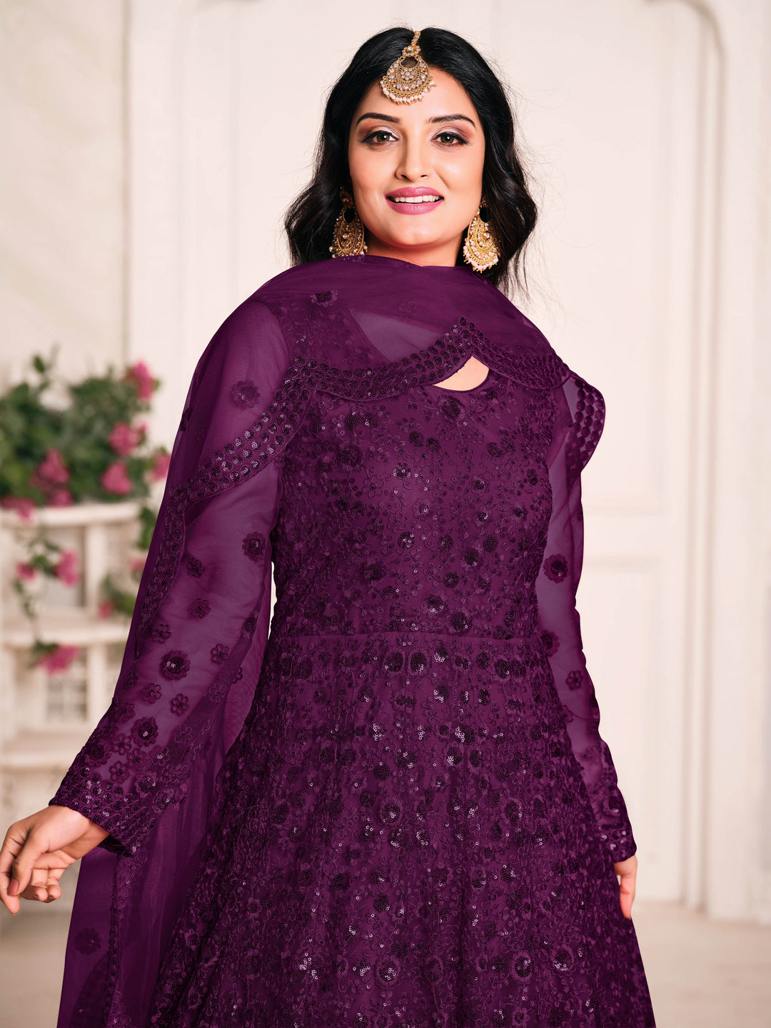 Beautifully crafted dark purple Anarkali suit set, ideal for weddings and festive gatherings with luxurious fabric and embellishments.