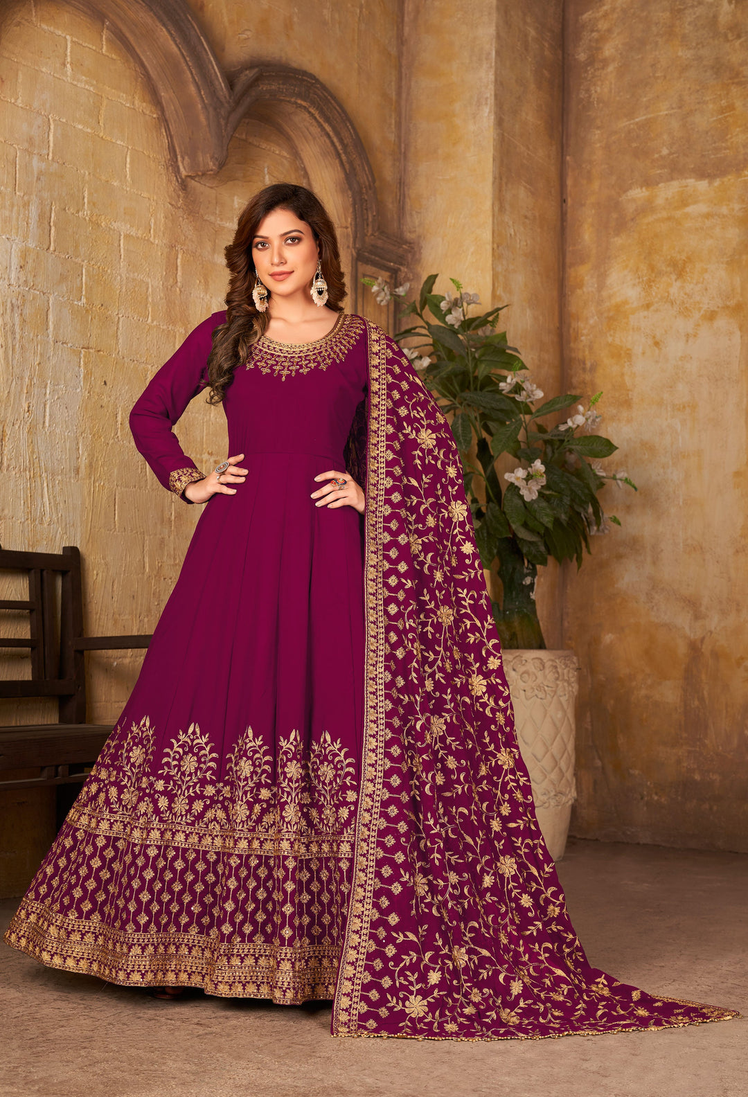 Vibrant magenta salwar kameez featuring a glamorous ensemble with intricate details, perfect for festive gatherings.