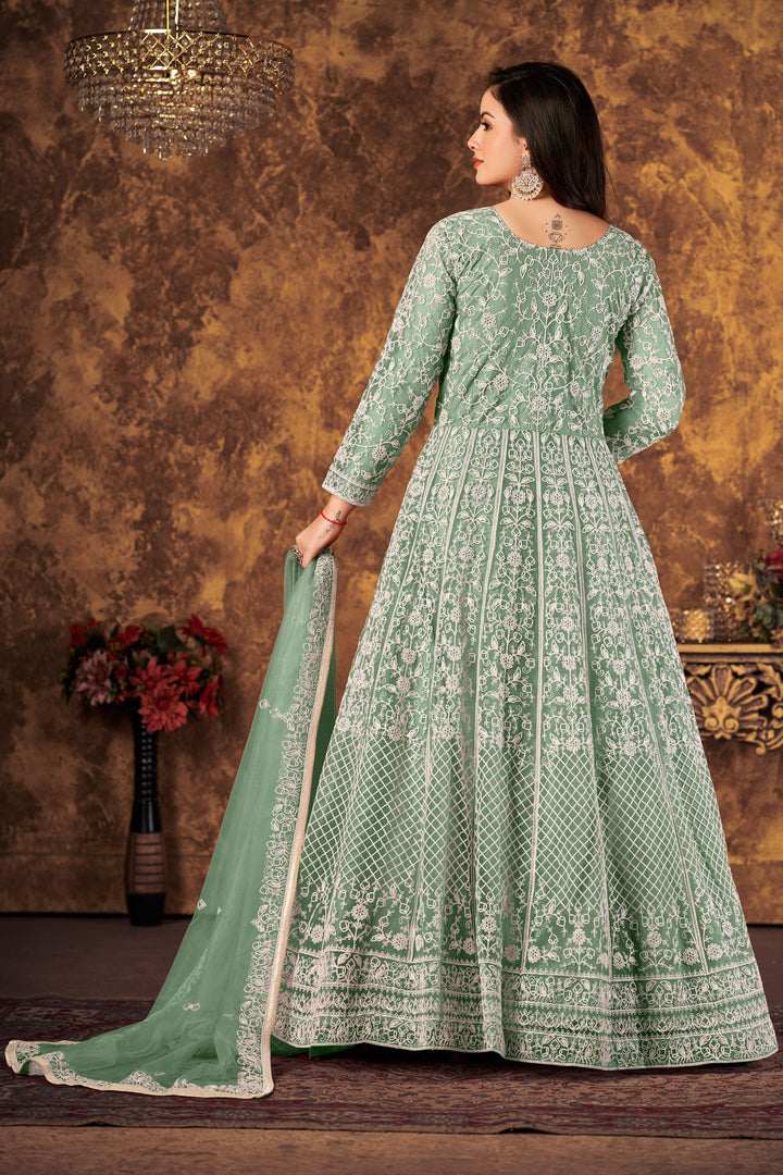 Elegant light green salwar kameez showcasing intricate design, perfect for enhancing your festive wardrobe.