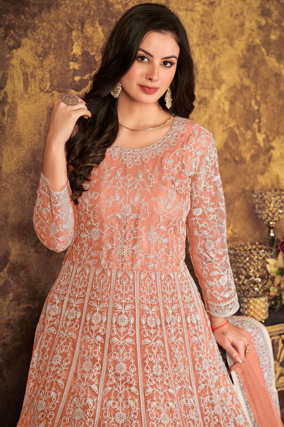 Beautifully crafted peach salwar kameez featuring exquisite design, perfect for weddings and special occasions.