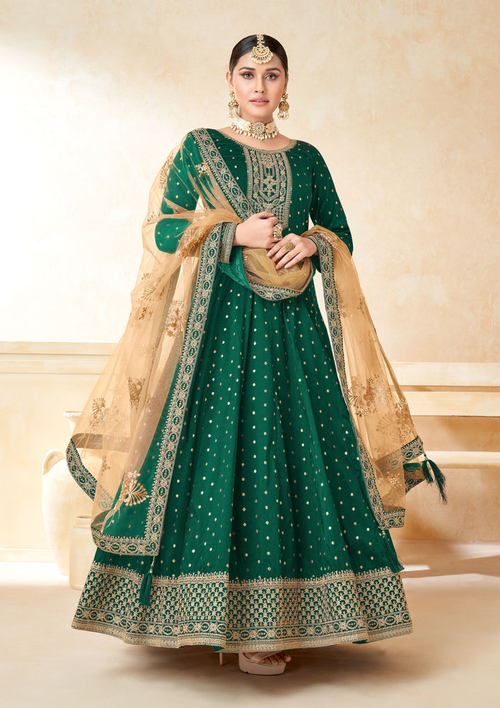 Celebrate tradition with green salwar kameez, a stylish combination of taffeta and net, perfect for festive occasions.