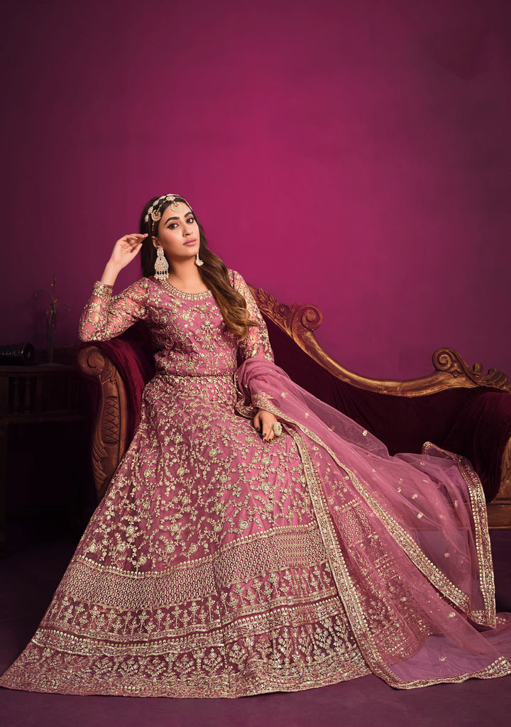 Delight in baby pink salwar kameez featuring a beautifully embroidered net top set, perfect for festive occasions.