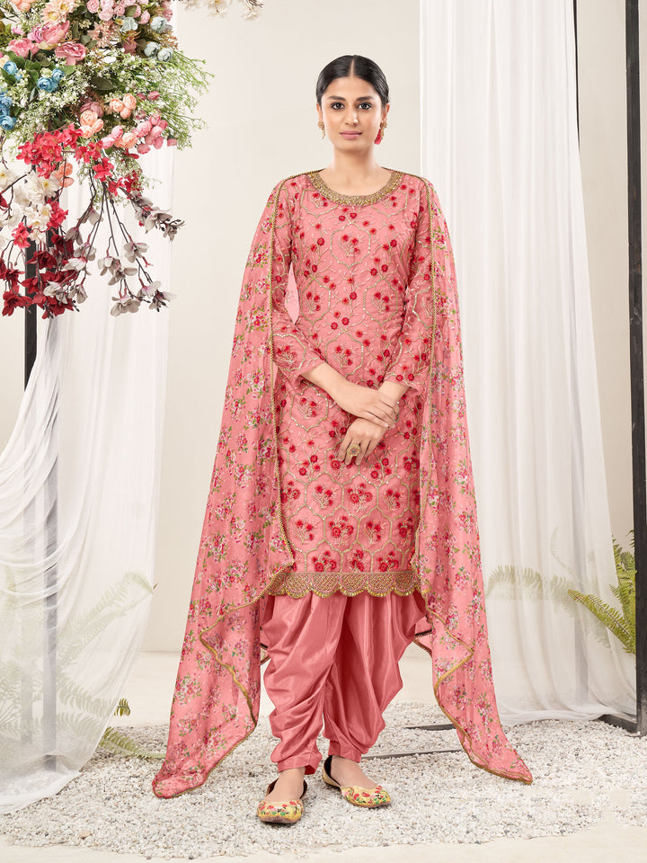 Pink net salwar kameez set featuring heavy embroidery and sequins, ideal for celebrations and special events.