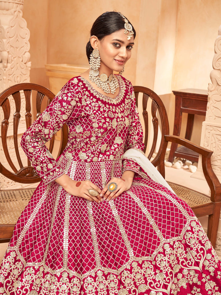 Luxurious ruby salwar kameez showcasing intricate detailing for weddings and events.