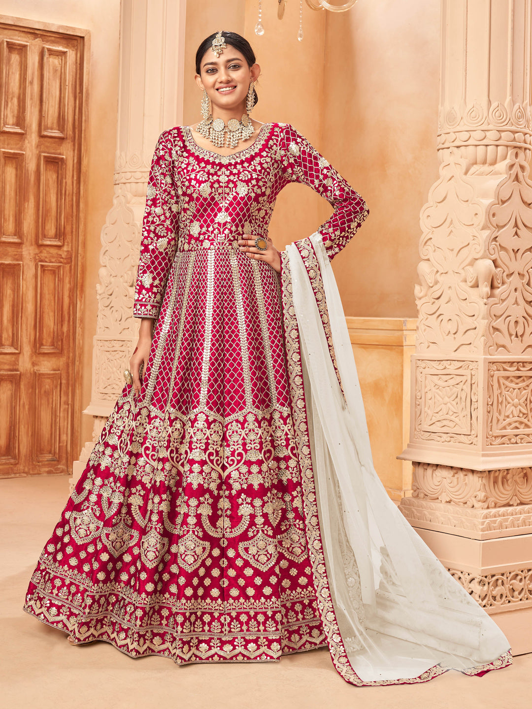 Ruby art silk salwar kameez featuring heavy thread embroidery with beautiful zari work.