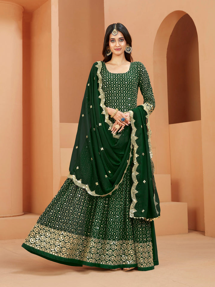 Green faux georgette salwar kameez featuring heavy thread embroidery with zari and sequins work.