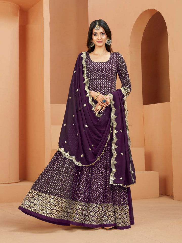 Purple faux georgette salwar kameez featuring heavy thread embroidery with zari and sequins work.