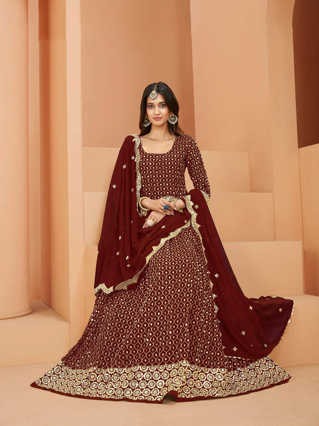 Luxurious maroon salwar kameez showcasing exquisite detailing for weddings and celebrations.