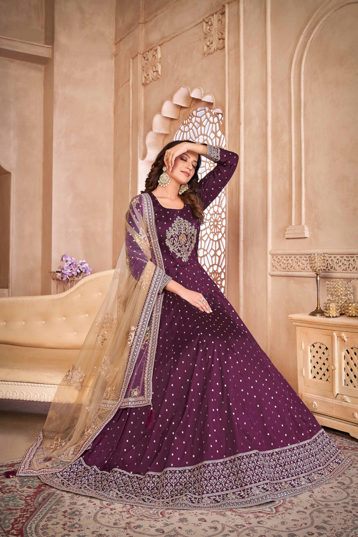 Chic wine taffeta salwar kameez with intricate embroidery and sequins, perfect for festive occasions.