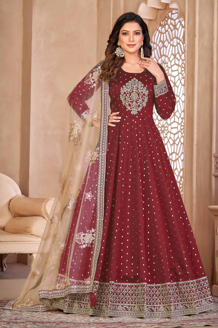 Maroon taffeta salwar kameez featuring butti design with heavy thread embroidery and sequins work.