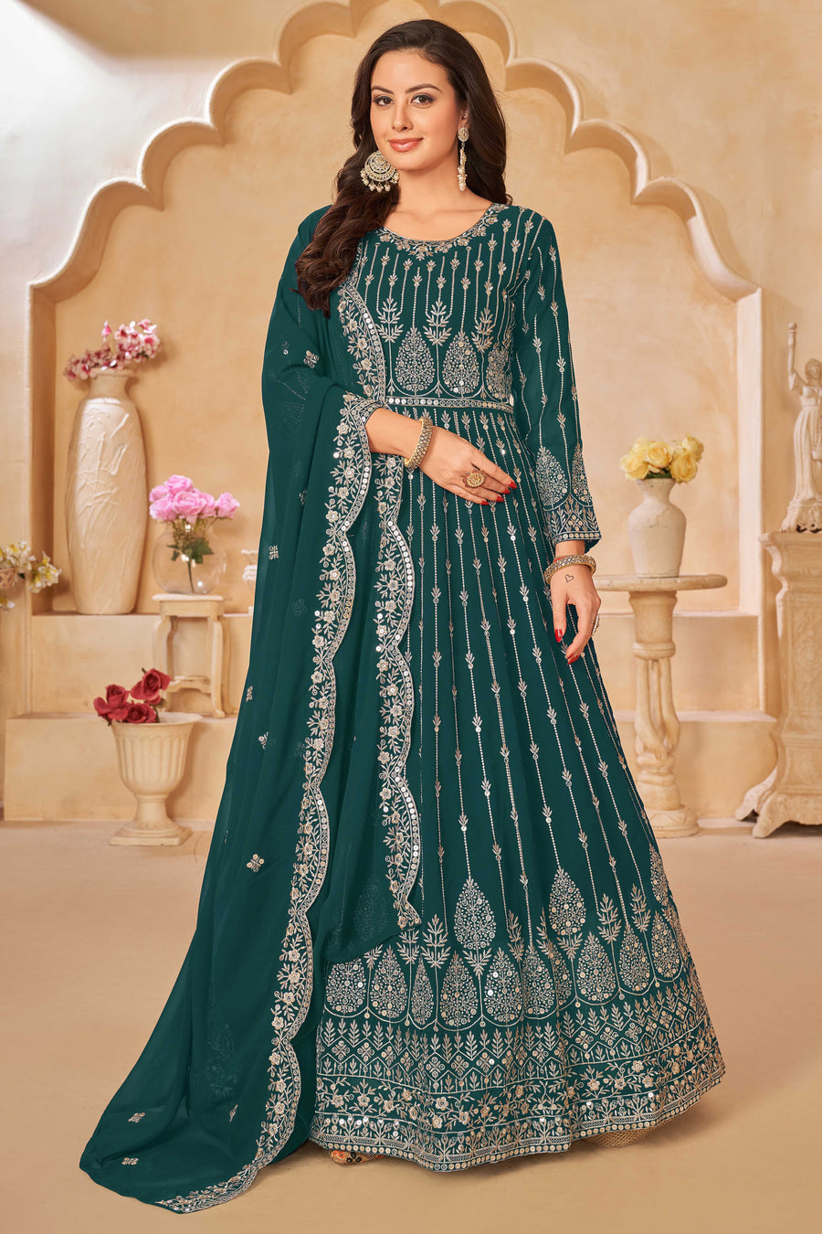 Teal green faux georgette salwar kameez featuring heavy thread embroidery with sequins work.