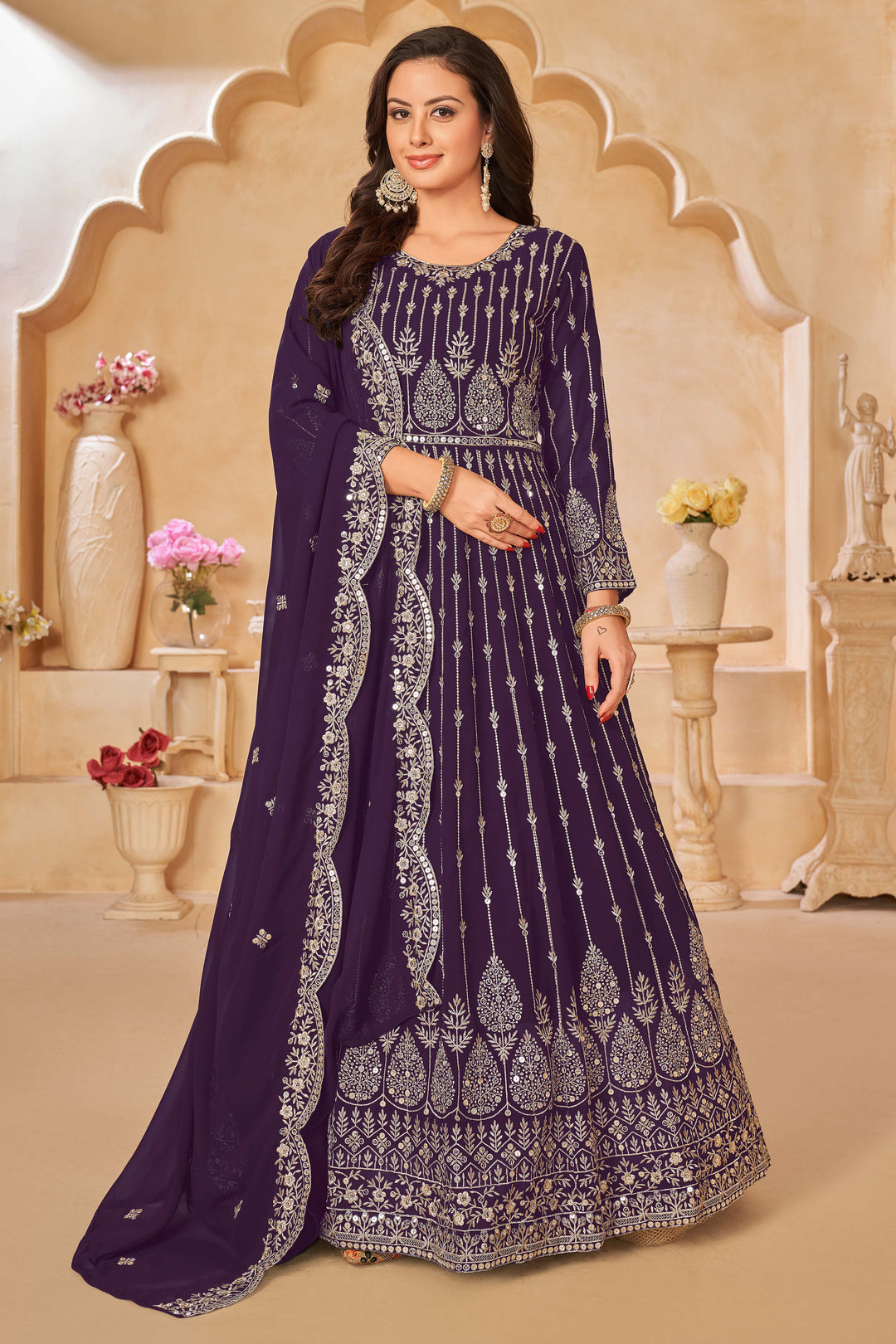 Purple faux georgette salwar kameez featuring heavy thread embroidery with sequins work.