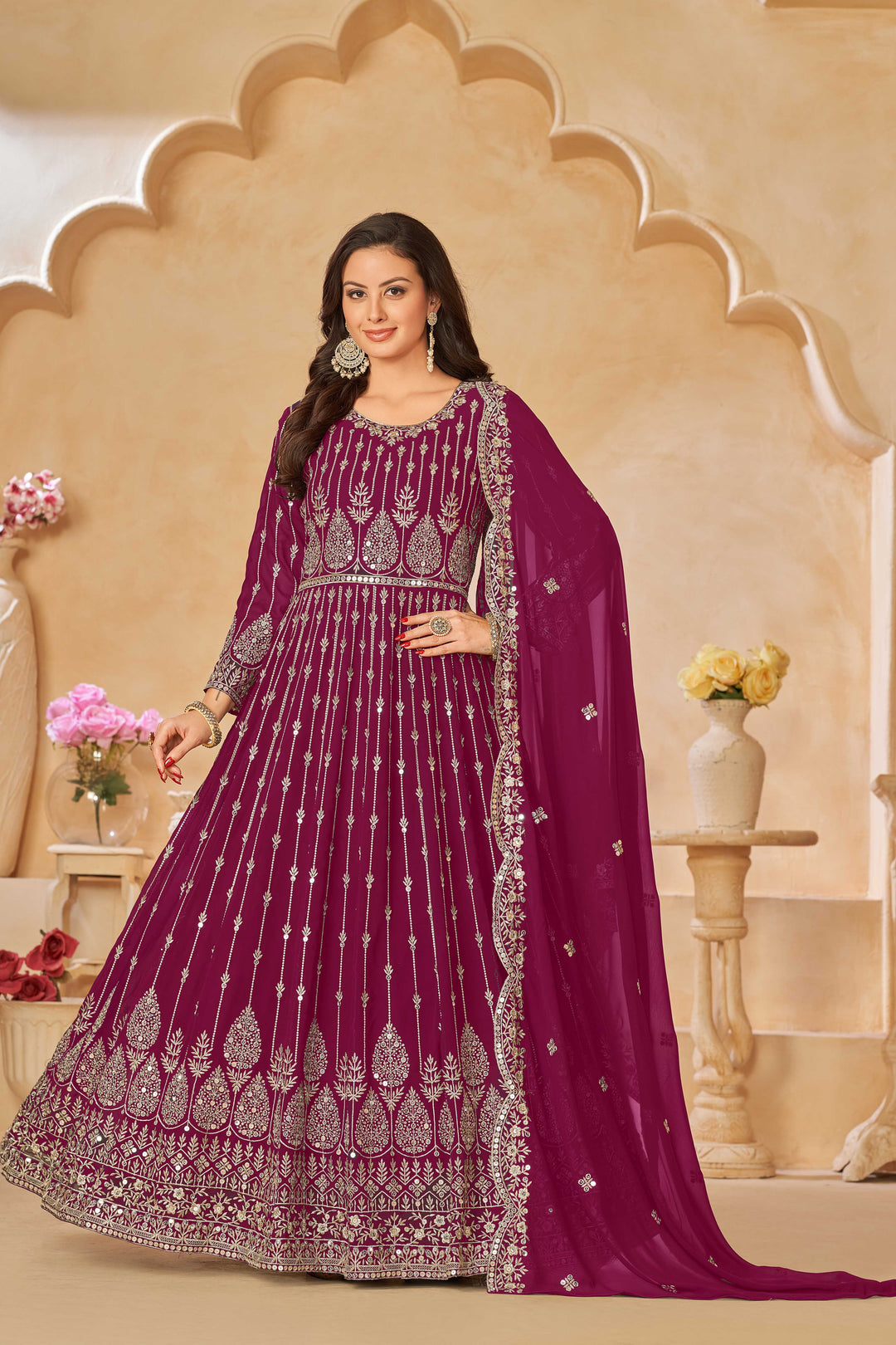 Stylish rani pink salwar kameez with intricate embroidery and sequins, ideal for festive occasions.