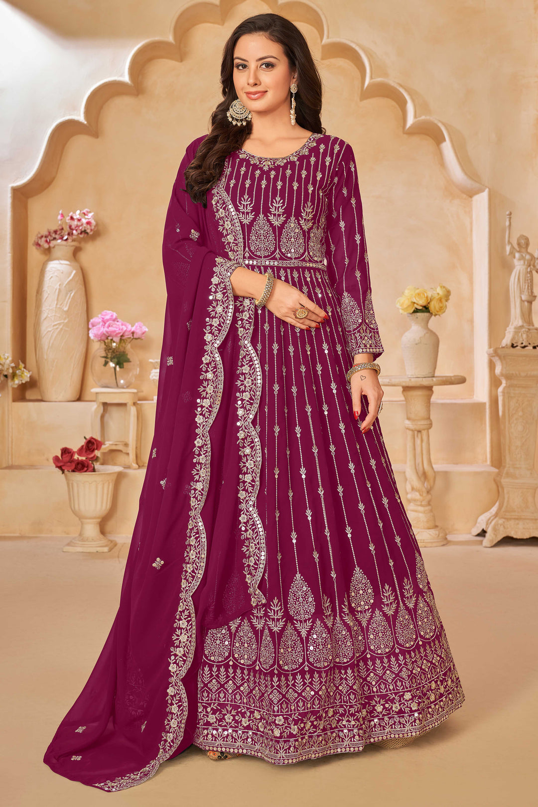 Rani pink faux georgette salwar kameez featuring heavy thread embroidery with sequins work.