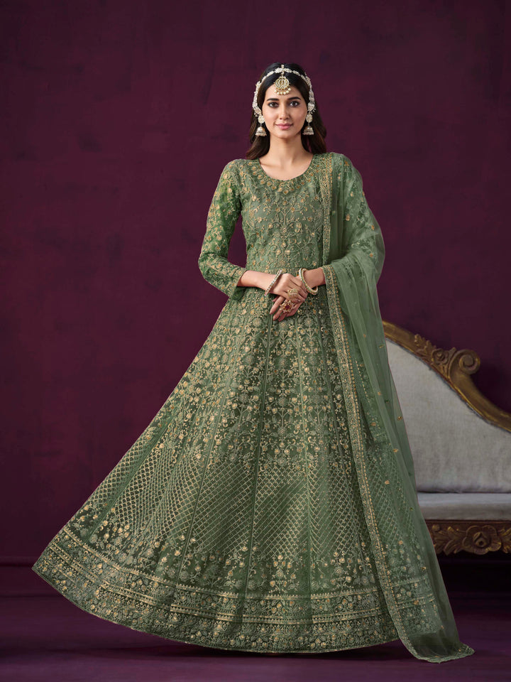 green net salwar kameez featuring heavy thread embroidery with zari and sequins work.