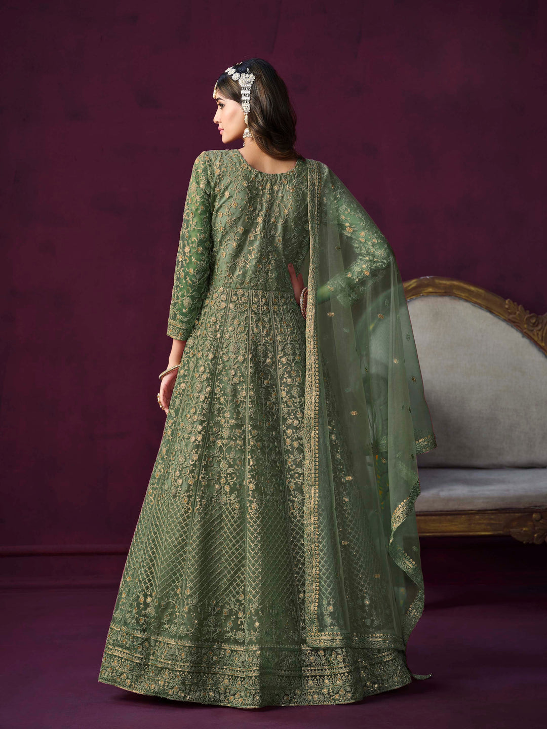 Chic mehendi net salwar kameez with intricate embroidery and zari, ideal for festive occasions.