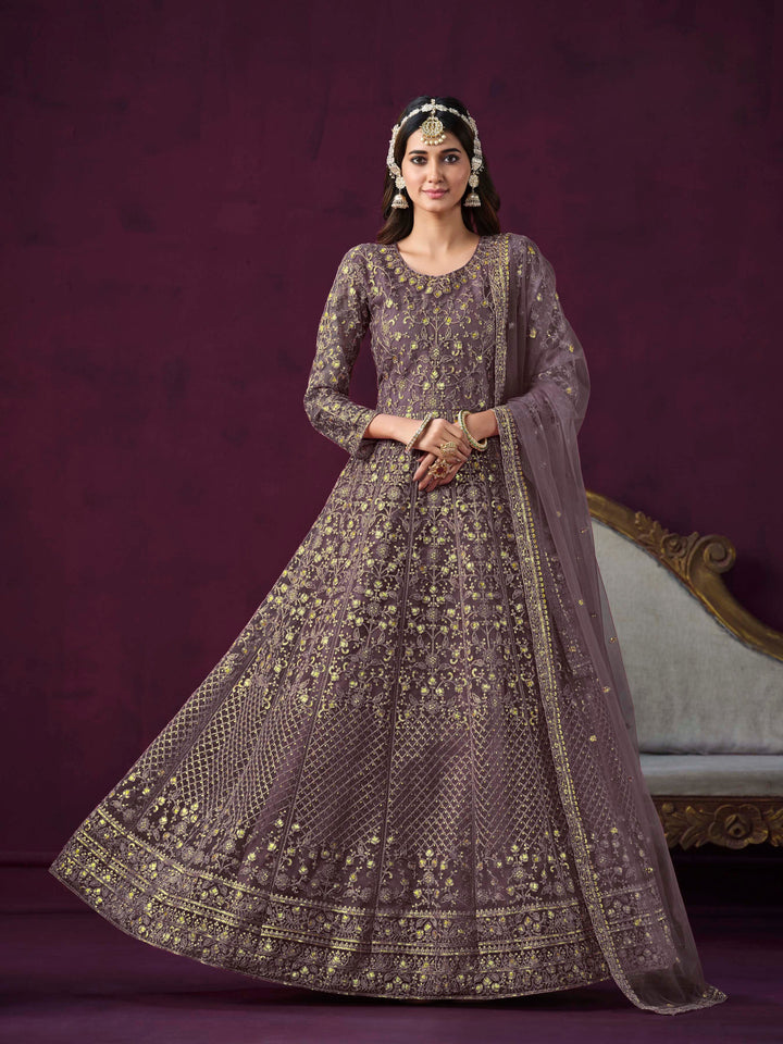 Dusty purple net salwar kameez featuring heavy thread embroidery with zari and sequins work.