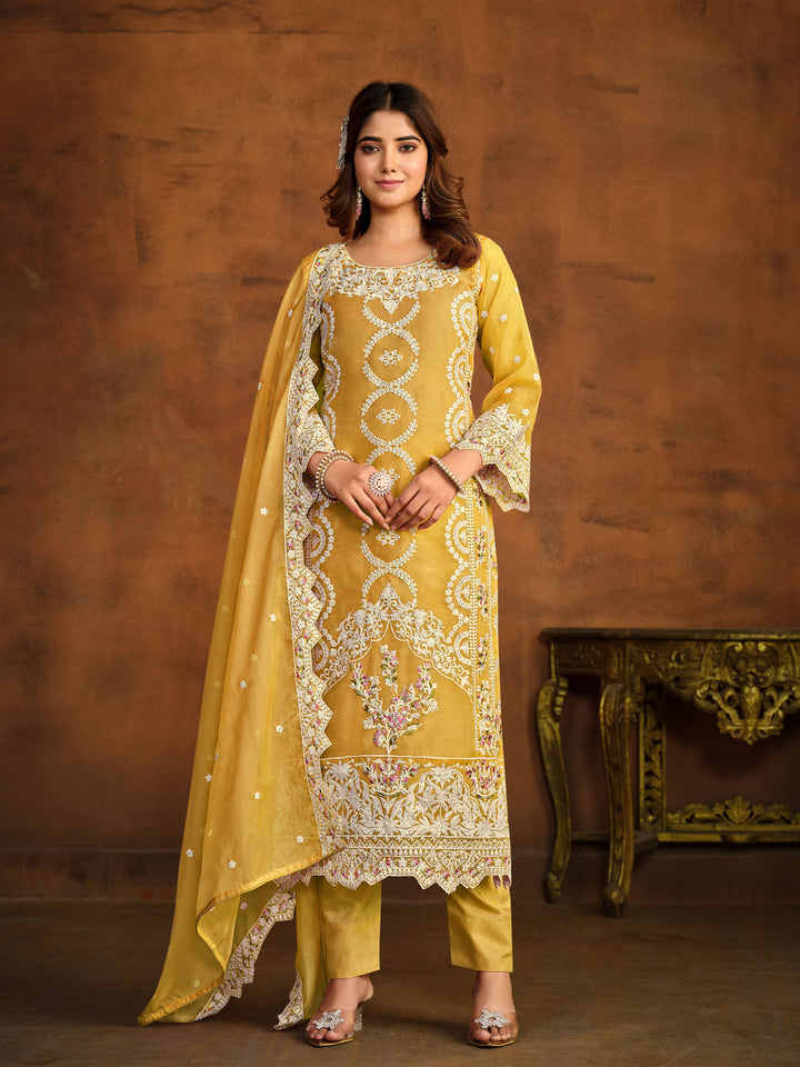 Yellow soft organza salwar kameez featuring heavy thread embroidery with sequins work.