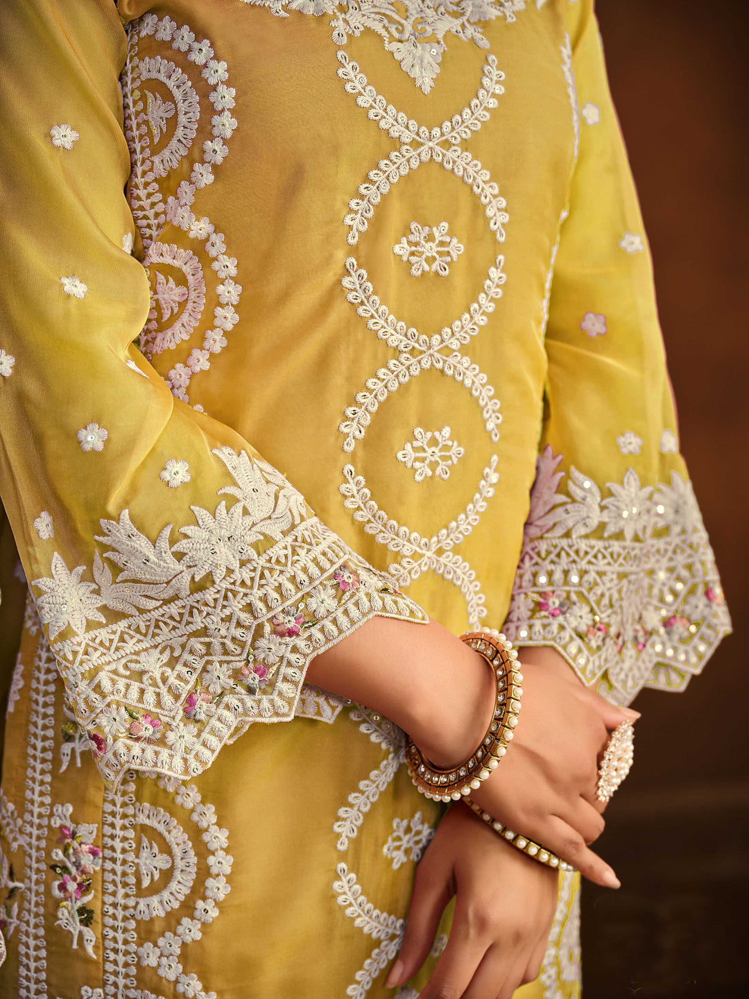 Chic yellow soft organza salwar kameez with heavy embroidery and sequins work, ideal for special occasions.