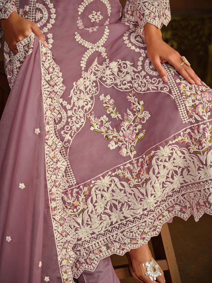 Stunning mauve salwar kameez showcasing intricate detailing for weddings and celebrations.