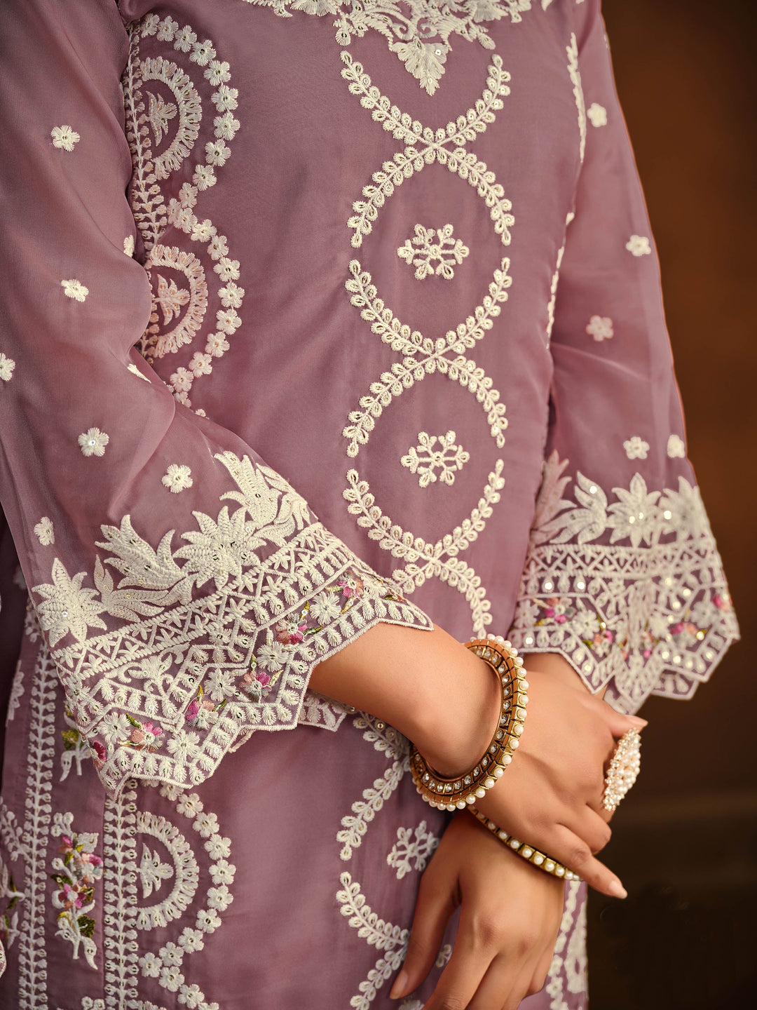 Chic mauve soft organza salwar kameez with heavy embroidery and sequins work, ideal for special occasions.