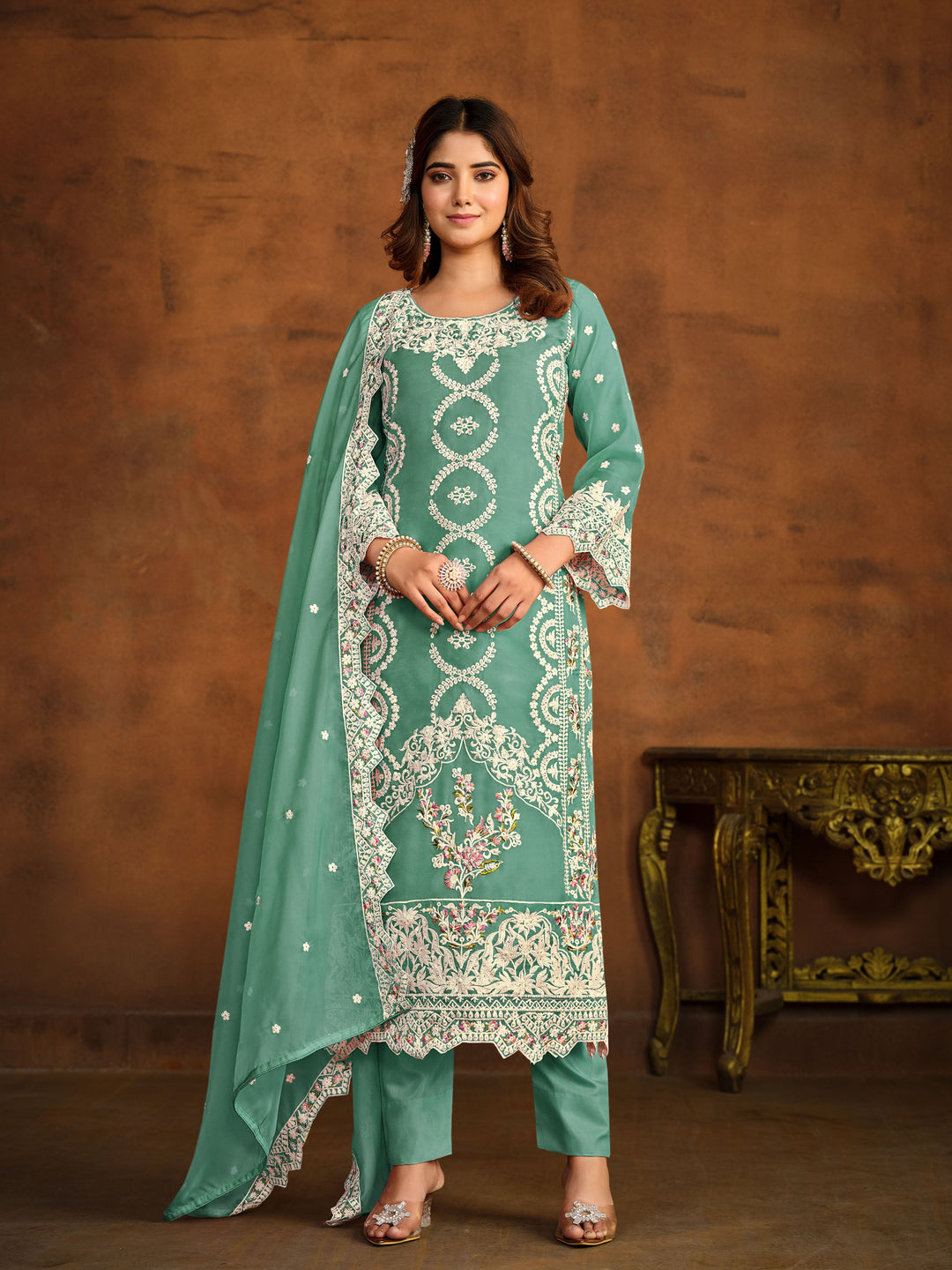 Light green soft organza salwar kameez featuring heavy thread embroidery with sequins work.