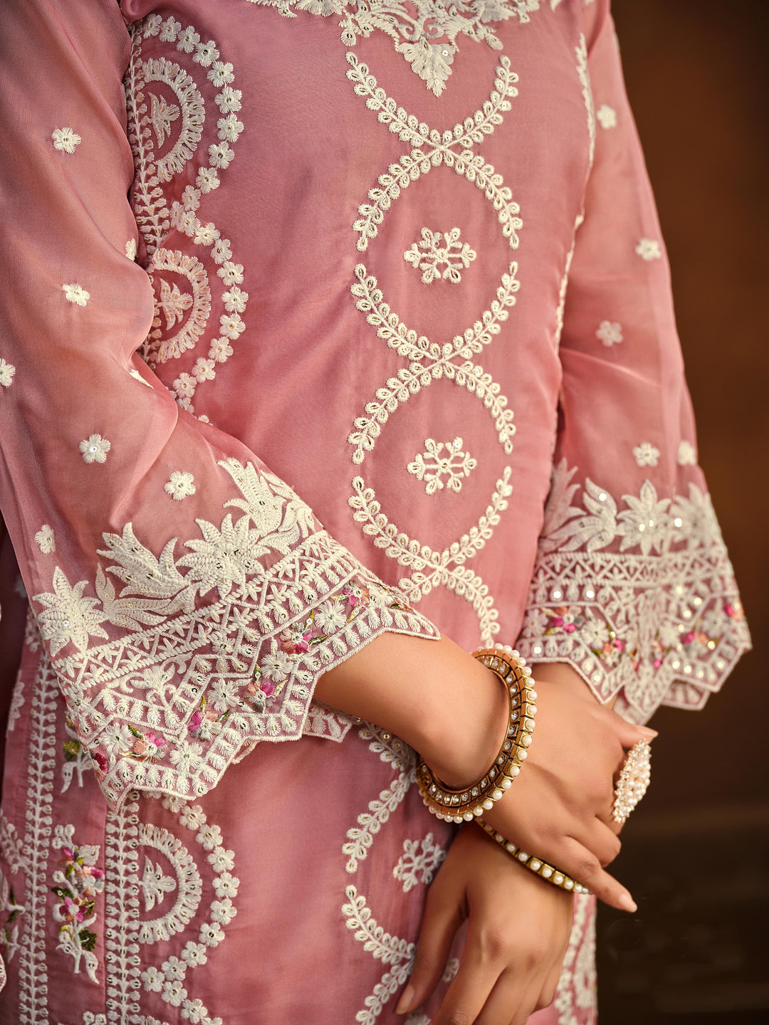 Chic pink soft organza salwar kameez with heavy embroidery and sequins work, ideal for special occasions.