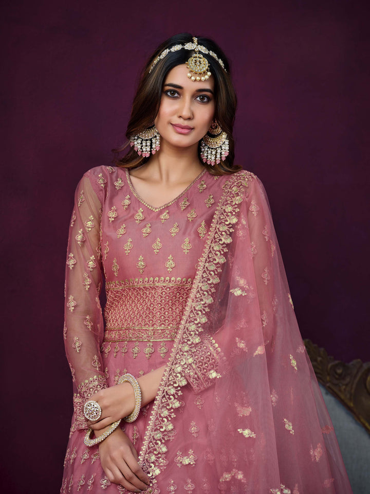 Luxurious pink salwar kameez showcasing exquisite detailing for weddings and events.